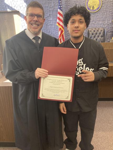 Pictured from left to right are Judge James Masteller and graduate Angel Cardona-Ramirez.