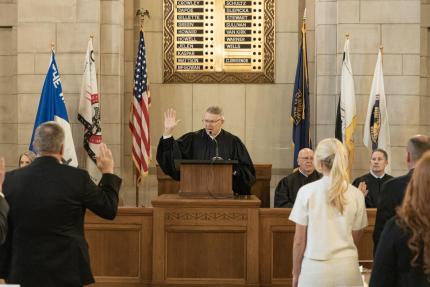 Chief Justice Heavican swears in new attorneys at ceremony.